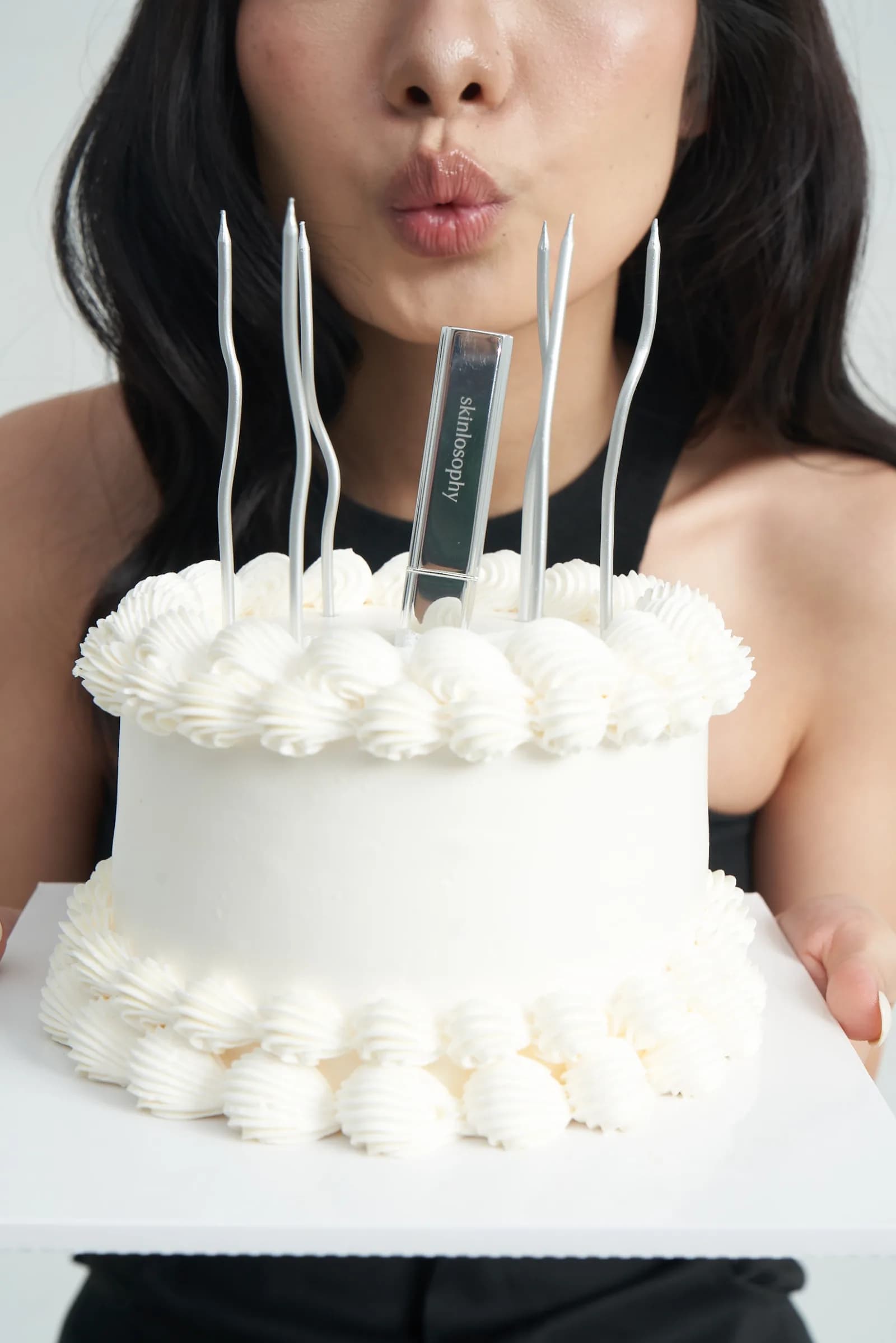 Người phụ nữ cùng chiếc bánh và thỏi son Skinlosophy